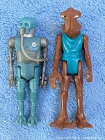 Front view of both figures showing overall condition and details