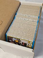 Row of blue-border hockey cards in cardboard box