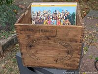 Front view of wooden butter crate holding LP sleeves