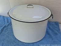 Front angle showing pot, lid, side handles, black trim