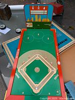 Overall view of electric baseball game board, playfield, plastic backdrop, player figures