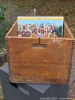 Front view of antique wooden box holding sample records