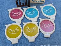All six colourful owl coasters laid out face up