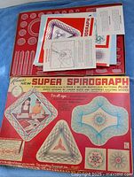 Open box showing red racks, gears, instruction sheets