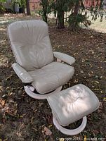 Full view of leather recliner and ottoman outdoors
