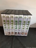 Front view of seven DVD season sets aligned