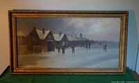 front view of framed painting showing winter village scene