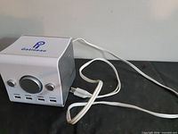 Front and side view showing speaker grille, USB cable