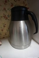 Full view of stainless steel coffee carafe showing exterior condition