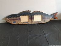 Full view of fish plaque folded open showing both photo windows