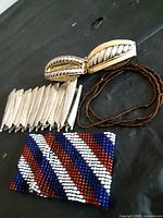 All four bracelets grouped: beaded cuff, gold-tone leaf stretch, silver-tone bar stretch, brown seed-bead trio