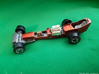 Side view of dragster showing body, wheels, engine