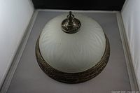 Top view of frosted glass dome ceiling light with finial