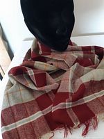 Full view of red plaid scarf draped on mannequin head