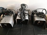 Three fog machines front view with cords