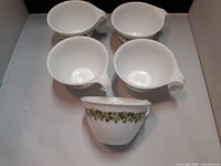 Top view of all five green floral CorningWare cups