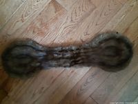 Top view of full mink fur collar on wood floor