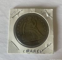Obverse view of coin in cardboard 2x2 flip showing Seated Liberty and date
