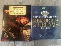 Front view of both hockey books showing covers with titles and themes related to hockey history and legends.
