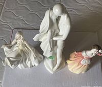 All three Royal Doulton figurines displayed together, showing size and detailing.