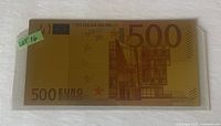 Front side of gold foil banknote showing 500 numeral and building motif