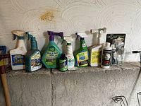 Full view of assorted spray bottles and containers lined up, showing product variety and packaging condition.