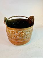 Full view of the vintage copper planter showing floral and bird hand-engraved designs and sturdy handle.