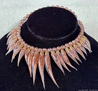 Front view of the vintage Murano glass choker necklace displayed on black stand.