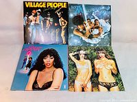 Four vinyl LP records album covers from Village People, Boney M, Donna Summer, and unknown artist