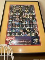 Full view of framed poster with all images and logos visible.