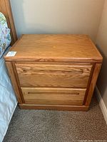Front view of one Thornwood wooden nightstand showing two drawers and minor scratches on top surface.