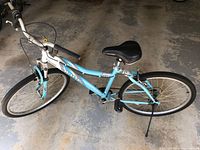 Full view of left side of bicycle showing frame, wheels, handlebar, and kickstand