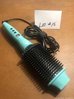 Full view of curling iron with cord and plug