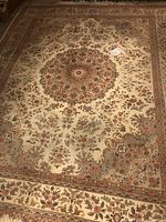 Full view of area rug showing pattern, border and fringe