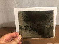 Monochrome glass plate daguerreotype held to light