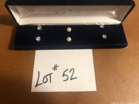 All three pairs of stud earrings in velvet case