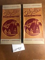 Front view of two Hazelle’s Marionettes boxes