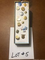 Overview of the 14 lapel pins mounted on display card