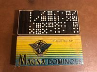 Open box showing domino tiles neatly arranged
