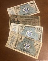 Group shot of four Military Payment Certificates showing denominations 50¢, 25¢ (two types) and 5¢