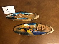 Both wood slice plaques front view with painted scenes
