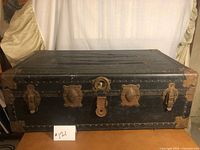 Front view showing trunk body, hardware and lock