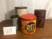 Group shot of four vintage tins
