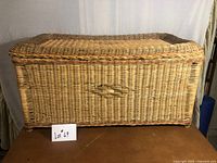 Front view of wicker chest showing weave pattern and overall condition