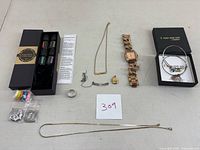 Full lot overview showing all jewelry items: 2 vintage nameplate necklaces, SLG locket, 2 Alex and Ani bracelets, rose gold-tone watch, ring, and diffuser necklace