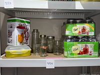 Shelf with two boxed sets of Ball quart jars, open pint jars, miscellaneous jars, spare lids, and Prepworks canning kit.