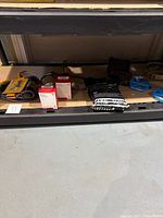 Shelf with bicycle accessories including bike tubes, pedals, locks, tire liners, phone holders, and hooks