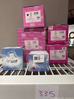 Stack of original boxes for the figurines showing label details and brand names