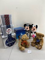 Displays all items in the lot including Mickey and Minnie Mouse dressed as bride and groom, two teddy bears, gift boxes, and the Graham and the Snowman gift set.
