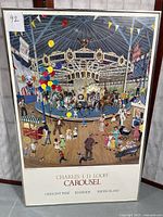 Full view of framed print showing carousel scene, signed and numbered